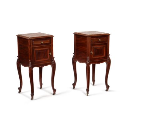 A pair of French mahogany bedside cabinets, late 19th/early 20th century, with marble inset tops and ceramic lined cupboard s