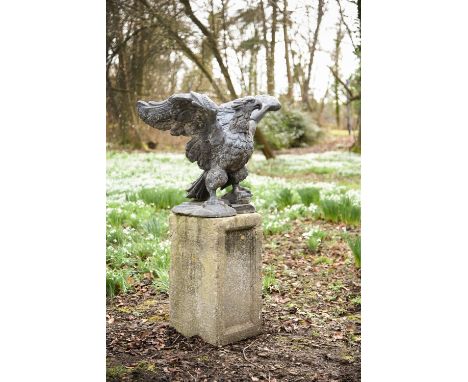 An English lead model of a spreadeagle, likely 19th century, with articulated feathers and standing atop a rockwork base, pre