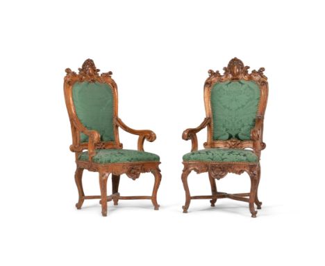 A pair of Continental carved walnut armchairs, first half 18th century, each 140cm high, 68cm wide, 53cm deep overall