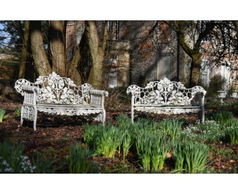 A pair of English white painted cast iron 'oak and ivy pattern' garden benches, in the manner of Coalbrookdale, late 19th/ear