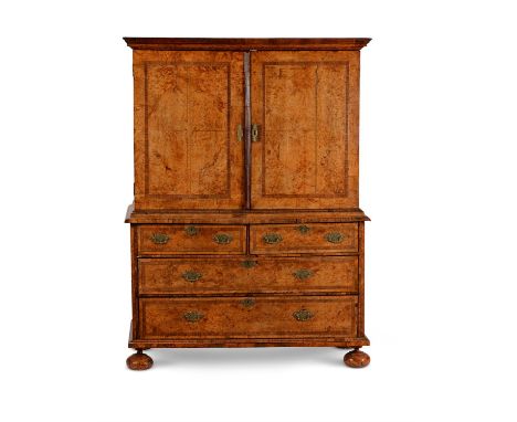 A George I mulberry, tulipwood crossbanded and brass inlaid cabinet on chest, circa 1720, the doors opening to a shelf, one l