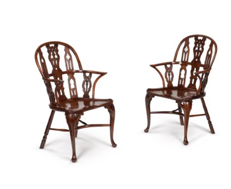 A pair of yew and mahogany Gothic Windsor armchairs, mid-18th century, attributed to Thames Valley, one stamped 'T.B' to the 