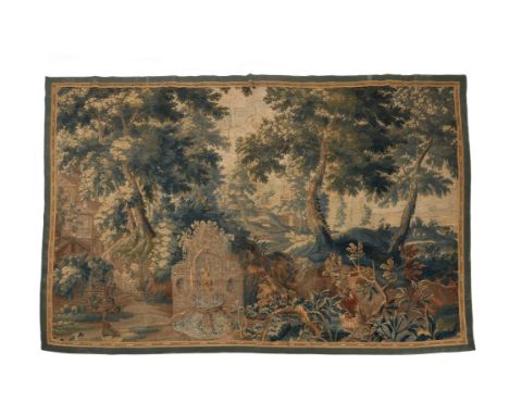 A Flemish verdure tapestry, last quarter 17th century, with a central fountain and further architectural elements within a ve