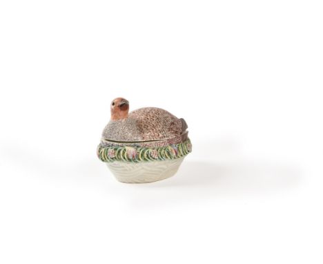 A Worcester partridge tureen and cover, circa 1758, typically decorated in coloured enamels and modelled seated on a nest, 15