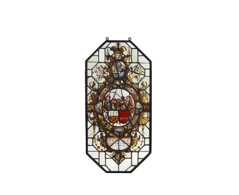 A Netherlandish stained and leaded glass armorial panel, 17th century, of elongated octagonal form, the central oval reserve 