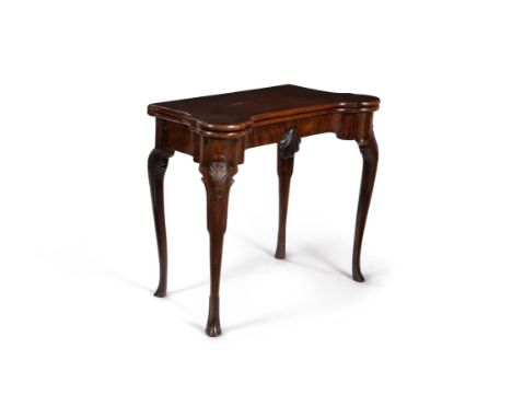 An Irish George II mahogany folding card table, circa 1750, the hinged top opening to a baize inset playing surface and count