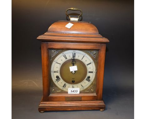 A mahogany cased bracket clock, silvered dial, Roman numerals, carrying handle