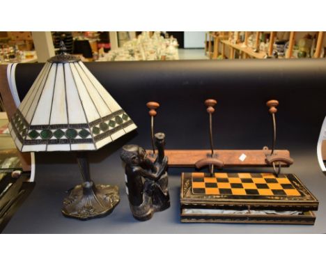 A folding chess/backgammon set; a tribal carving; a table lamp; a cloakroom coat rack (4)