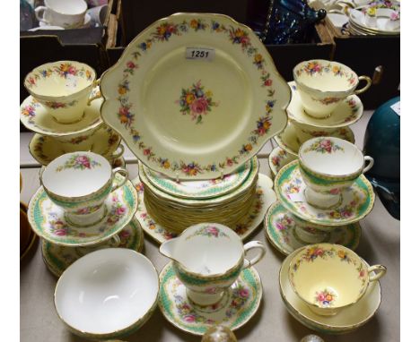 A Paragon six setting tea service, printed with colourful English flowers, comprising teacups, saucers and tea plates, bread 