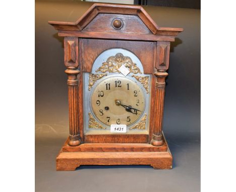 An oak cased mantel clock, silver and gilt dial, Arabic numerals