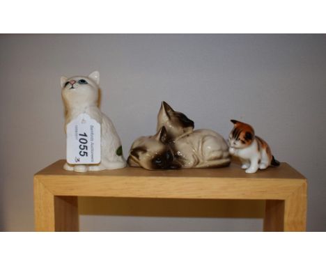 A Beswick group, of Siamese cats, printed marks; another, single cat; a Royal Doulton model, of a cat, printed marks 