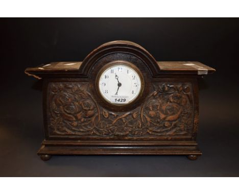 An Arts and Crafts style mahogany mantel clock, replacement quartz movement