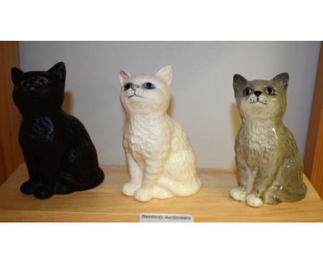 A Beswick seated kitten; two Royal Doulton seated kittens (3)