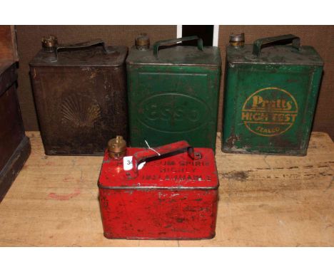Four vintage petrol cans including Shell, Esso and Pratts.