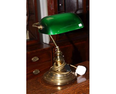 Brass desk lamp with green glass shade.