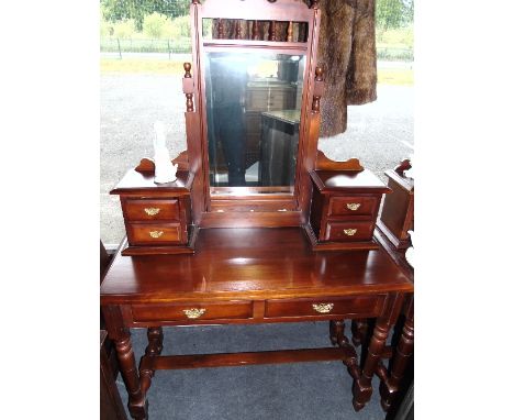 A Mahogany Dressing Table, 20th Century, with bevelled mirror flanked either side by two trinket drawers with brass handles, 