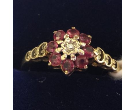 A 9ct. Gold Diamond and Ruby Cluster Ring. Size M.