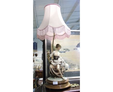 A Porcelain Lamp in the Form of a Maiden & Lamb, on a timber base, with shade.