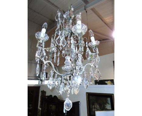 A Fine Five-Light French Chandelier, profusely hung with cut plates and drops over the silvered brass frame, circa 1910.