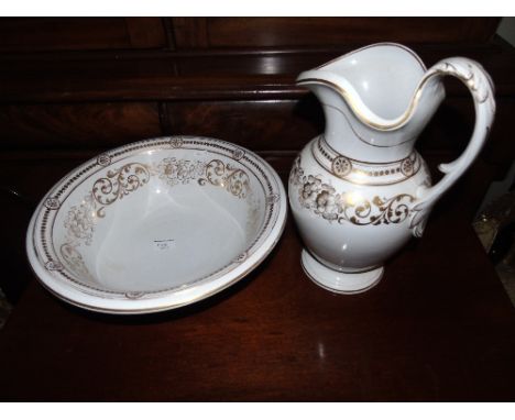 A Victorian Jug and Basin with gilt decoration on a white ground.