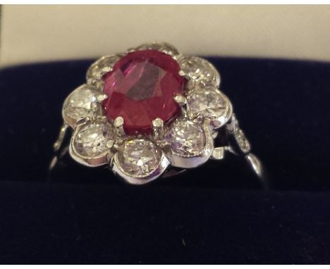 An 18ct. White Gold Diamond and Ruby Ring. Size N. Ruby 1.5 carat, Diamond 1.2 carat (approx).