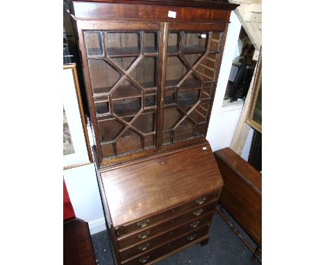 A Georgian Style Mahogany Bureau Bookcase with decorative pigeon holes, four graduated drawers and bracket feet. 66ins high x