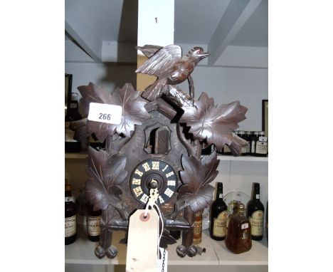A Black Forest Style Carved Wooden Cased Cuckoo Clock.