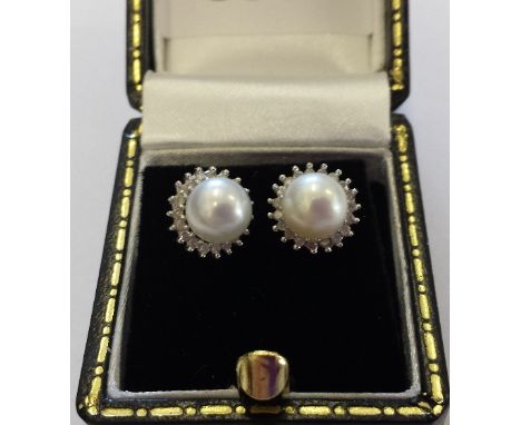 A Pair of White Gold Diamond and Pearl Earnings.