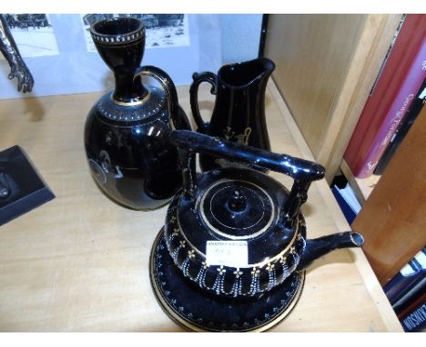 A Black Victorian Ceramic Tea Kettle on Stand, together with two further pieces of pottery (3).