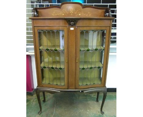 An Edward VII mahogany and inlaid serpentine china display cabinet enclosed by a pair of leaded light glazed doors. 42' wide