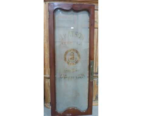 Architectural Antiques. An early 20th century Opticians shop door with full length bevelled glass pane acid etched with pract