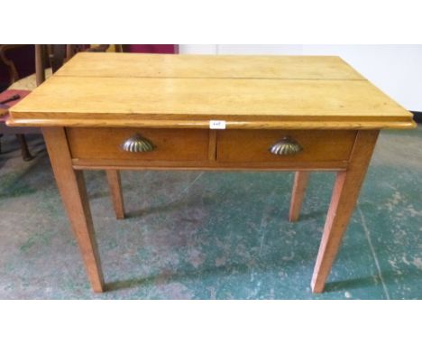 A light oak side table with two frieze drawers on square tapered legs. 41' wide