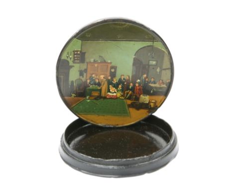 A 19TH CENTURY LACQUER SNUFF BOX, circular, the cover depicting an interior with figures, the underside titled The Rent Day. 
