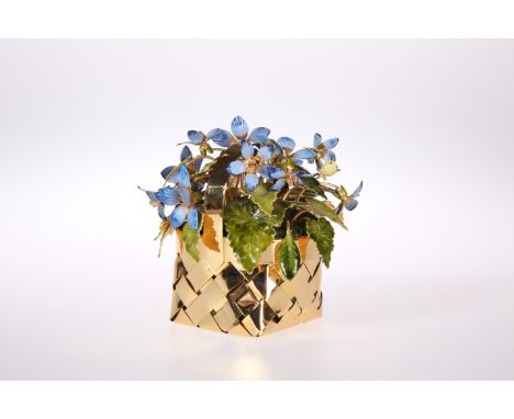 A STERLING SILVER-GILT AND ENAMEL BASKET OF FLOWERS, BY CARTIER, the woven gilt basket, filled with stylised blue flowers and