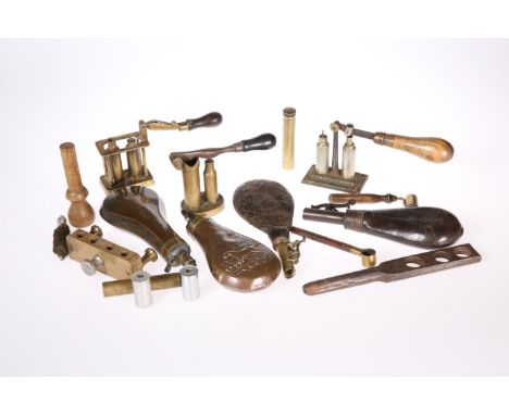 A COLLECTION OF SHOOTING ACCESSORIES, including copper shot flasks and loading equipment, in a Compass bag.