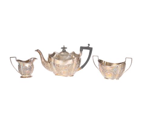 A LATE VICTORIAN SILVER BACHELORS TEA SERVICE, CHESTER 1896, chased and embossed with C-scrolls and foliage. Gross 13.5 troy 