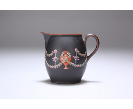 A LATE 18TH CENTURY BASALT JUG, POSSIBLY WEDGWOOD, enamel painted with floral swags and urns against a black ground. 8.5cm