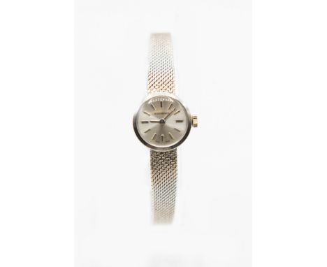 A LADY'S 14CT WHITE GOLD BUCHERER BRACELET WATCH.&nbsp;Circular silver dial with baton index and hands, integral Milanese mes