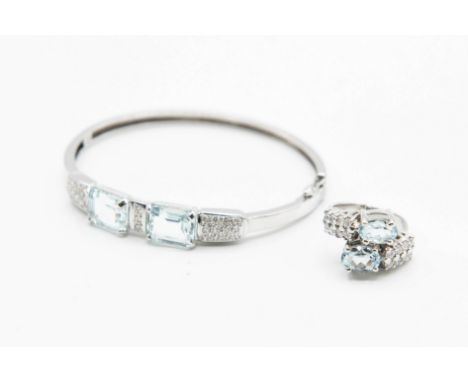 A CONTEMPORARY DIAMOND AND AQUAMARINE BANGLE, the two principal rectangular cut aquamarines alternately set with three plaque