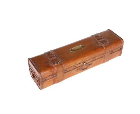 AN EDWARDIAN CARVED WOODEN TRAVELLING WRITING BOX&nbsp;IN THE FORM OF A LEATHER TRUNK, the interior with an inkwell in the fo