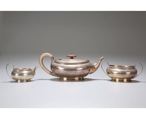 A GEORGE V SILVER THREE-PIECE TEA SERVICE, ADIE BROTHERS, BIRMINGHAM 1932, of oval section with reel moulded rims. 21 troy ou