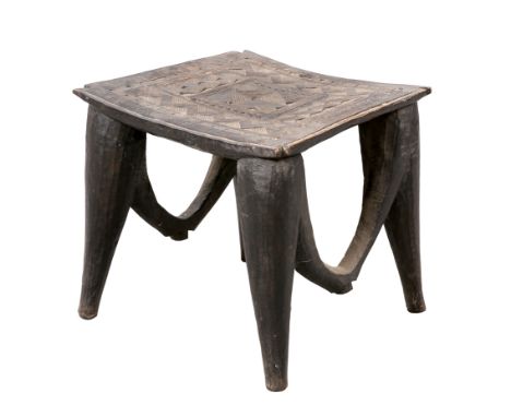 A NIGERIAN NUPE STOOL, the square top with geometric carving. 39.5cm high, 42cm wide