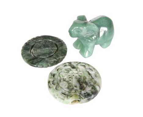 TWO CHINESE CARVED JADE ROUNDELS, the first a pendant, pierced and carved to one side with a bird, the second pierced and wit