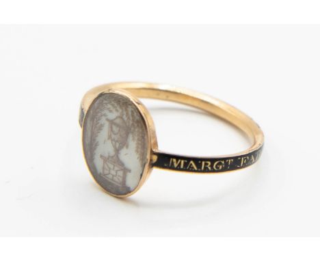 A GEORGIAN MEMORIAL RING, the oval mount with pencil drawing of an urn on a black enamel band with gold wording "Margt. Farqu