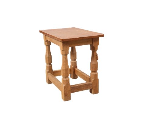 ROBERT THOMPSON OF KILBURNA MOUSEMAN OAK STOOL (OR OCCASIONAL TABLE), the adzed rectangular top raised on faceted baluster le