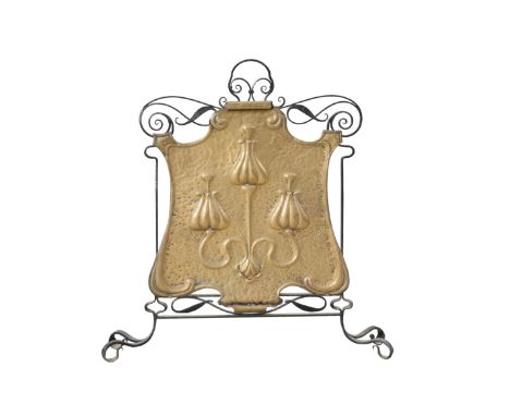 AN ARTS AND CRAFTS BRASS AND WROUGHT IRON FIRESCREEN, the cartouche shaped brass panel repousse with stylised plantform. 74cm