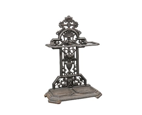 A VICTORIAN CAST IRON STICKSTAND, with twin stick holders and trays, cast with vase, cornucopia, shell and fish, registration