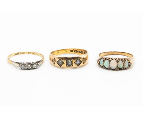 THREE GOLD GEM SET RINGS, one set with three seed pearl highlights on heavy tapering band, stamped 15, ring size Q; one set w