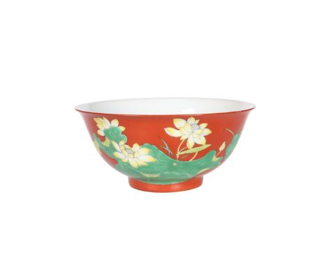 A CHINESE RED GROUND BOWL, green and yellow enamel painted with foliage, bears blue seal mark to base. Diameter 15cm