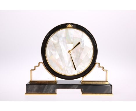 A CARTIER ONYX AND MOTHER-OF-PEARL SUNBURST DESK CLOCK, the circular dial composed of mother-of-pearl segments with gilt hand